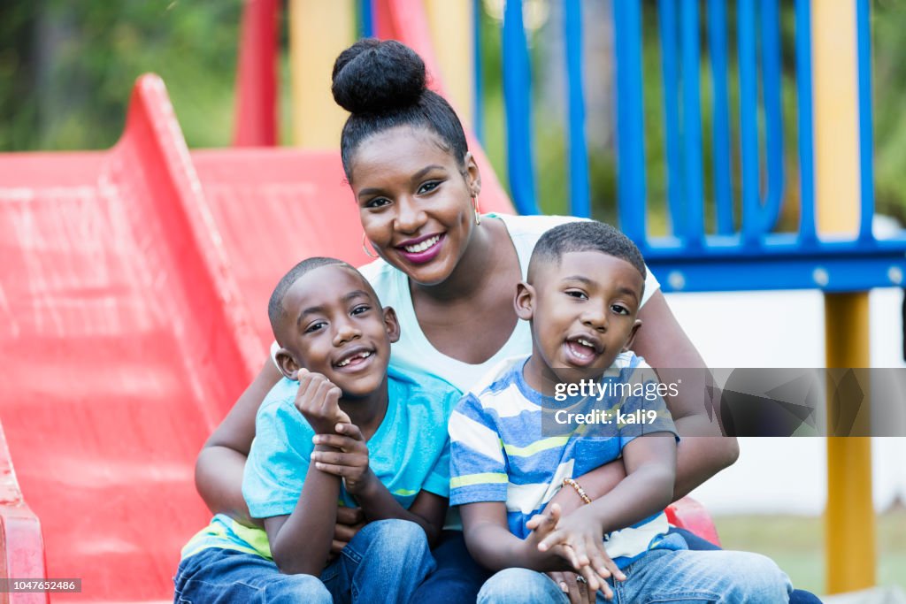 African-American woman with sons on playground