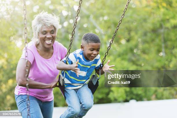 african-american senior woman, grandson on swing - playing with grandkids stock pictures, royalty-free photos & images