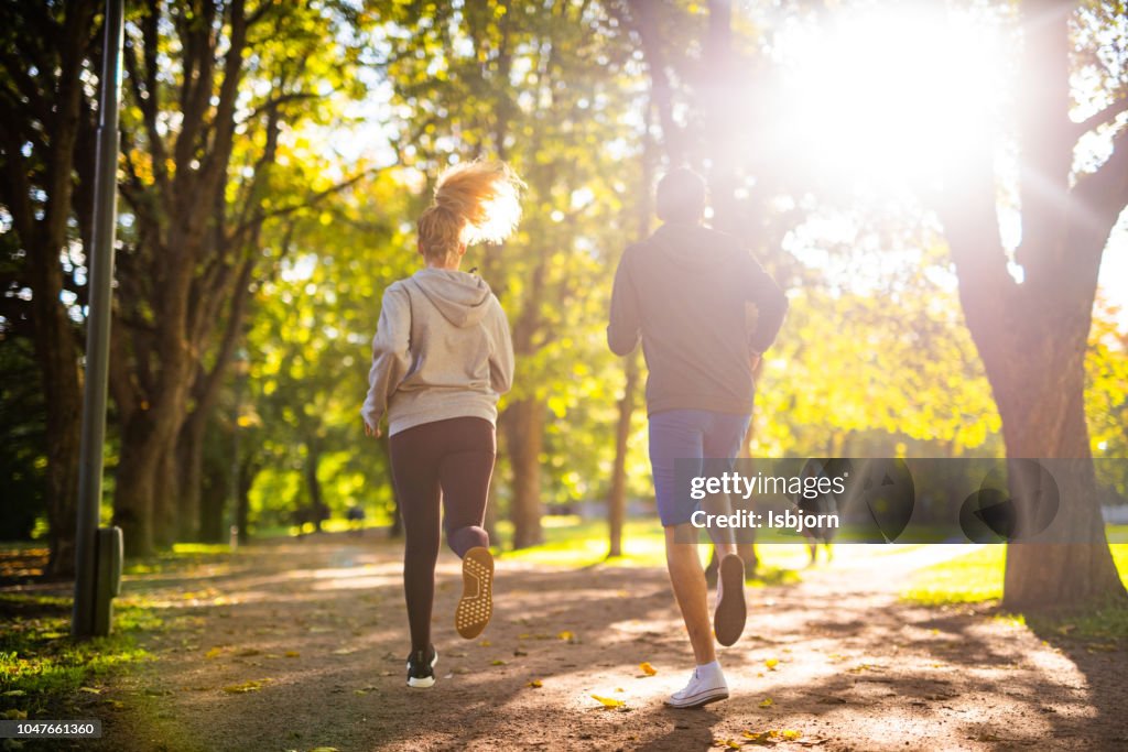 Couple exercising in park.