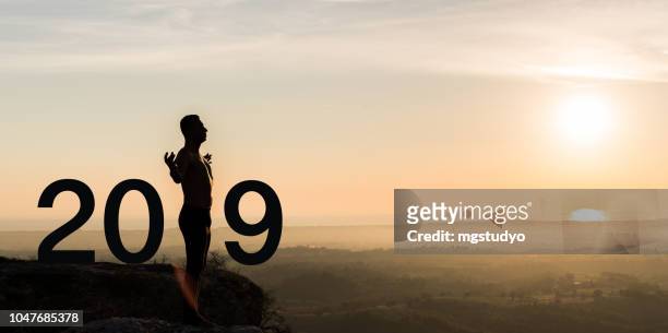 man  practicing yoga during the celebration new year 2019 - new year new you 2019 stock pictures, royalty-free photos & images