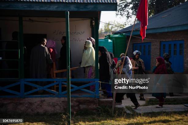 Kashmiris enter a polling station to cast their votes during the first phase of municipal polls, on October 8, 2018 in Srinagar, the summer capital...