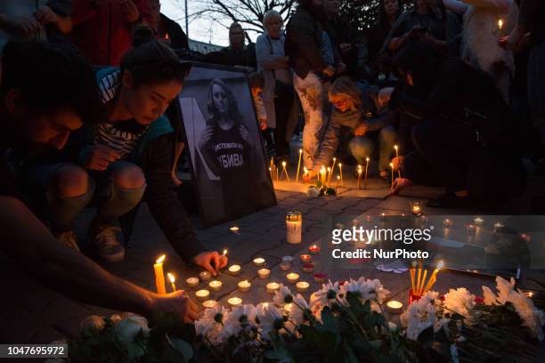 People light candles during a vigil for murder victim Viktoria Marinova in Sofia, on Monday, Oct. 8, 2018. The near the Danube River in the city of...