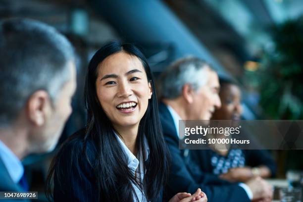 cheerful relaxed businesswoman with manager in meeting - asia stock-fotos und bilder