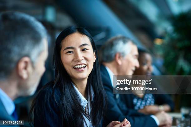 cheerful relaxed businesswoman with manager in meeting - fotos international portraits stockfoto's en -beelden