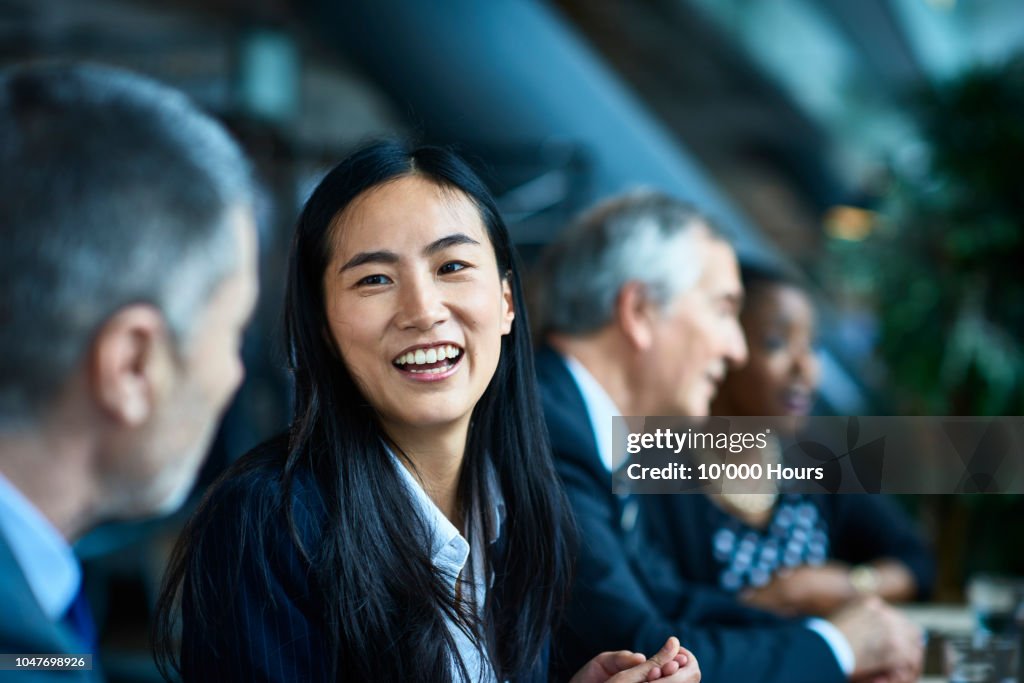 Cheerful relaxed businesswoman with manager in meeting