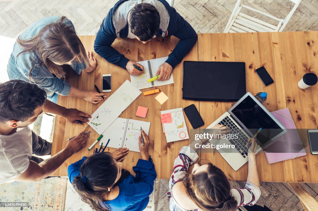 Overhead view on business people around desk