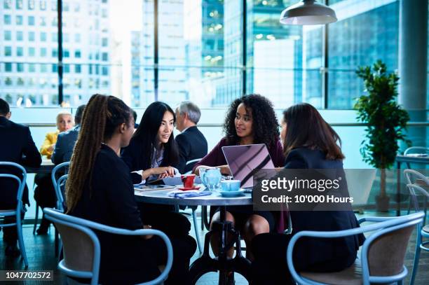 team of businesswomen discussing work over coffee break - inspiring women luncheon ストックフォトと画像