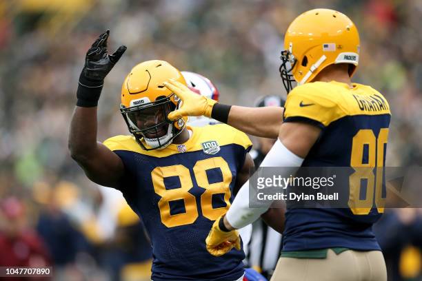Ty Montgomery and Jimmy Graham of the Green Bay Packers celebrate in the first quarter against the Buffalo Bills at Lambeau Field on September 30,...