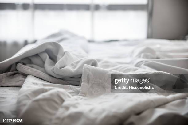 close up van verfrommeld bedlinnen op een hotelkamer - linnen stockfoto's en -beelden