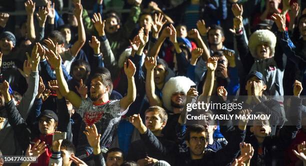 Fans of UFC lightweight champion Khabib Nurmagomedov of Russia shout during a meeting upon the arrival at the Anzhi-arena stadium in Makhachkala on...