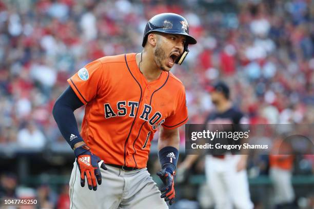 Carlos Correa of the Houston Astros celebrates as he runs the bases after hitting a three-run home run in the eighth inning against the Cleveland...