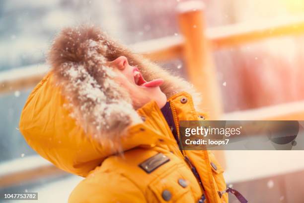boy catching snowflakes with mouth - catching snowflakes stock pictures, royalty-free photos & images