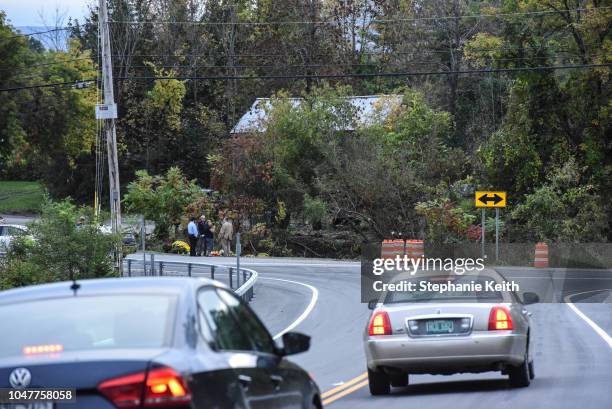 People mourn at the site of the fatal limousine crash while cars approach the crash site on October 8, 2018 in Schoharie, New York. 20 people died in...