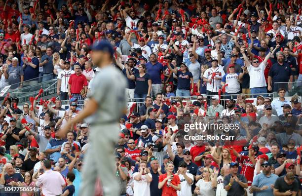 The crowd cheers after pitccher Rich Hill of the Los Angeles Dodgers gives up a two run RBI single to pinch hitter Kurt Suzuki of the Atlanta Braves...