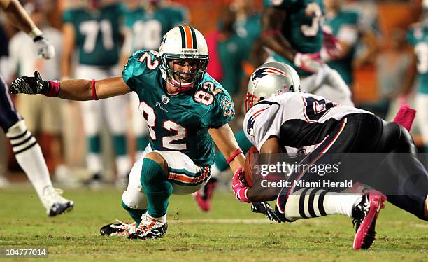 Miami Dolphins' Brian Hartline watches the New England Patriots' Jarrad Page intercept a pass late in the fourth quarter at Sun Life Stadium in Miami...