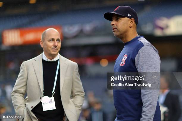 General Manager of the New York Yankees Brian Cashman and manager Alex Cora of the Boston Red Sox talk during batting practice prior to Game 3 of the...