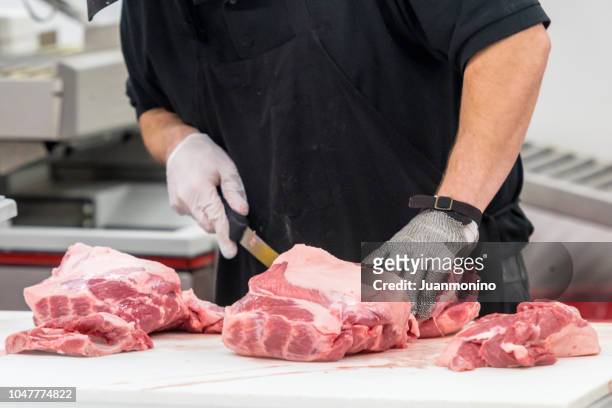 butcher at work - cutting stock pictures, royalty-free photos & images