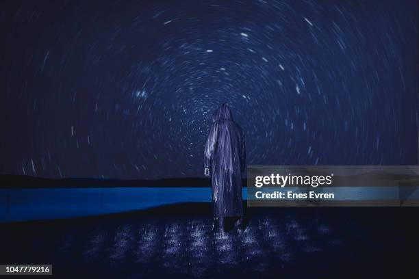 spooky man watching stars in nature - light painting and long exposure - light painting stock pictures, royalty-free photos & images