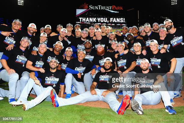 The Los Angeles Dodgers pose together on the field after winning Game Four of the National League Division Series with a score of 6-2 over the...