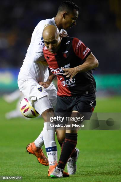 Agustin Almendra of Boca Juniors fights for the ball with Clemente Rodriguez of Colon during a match between Boca Juniors and Colon as part of...