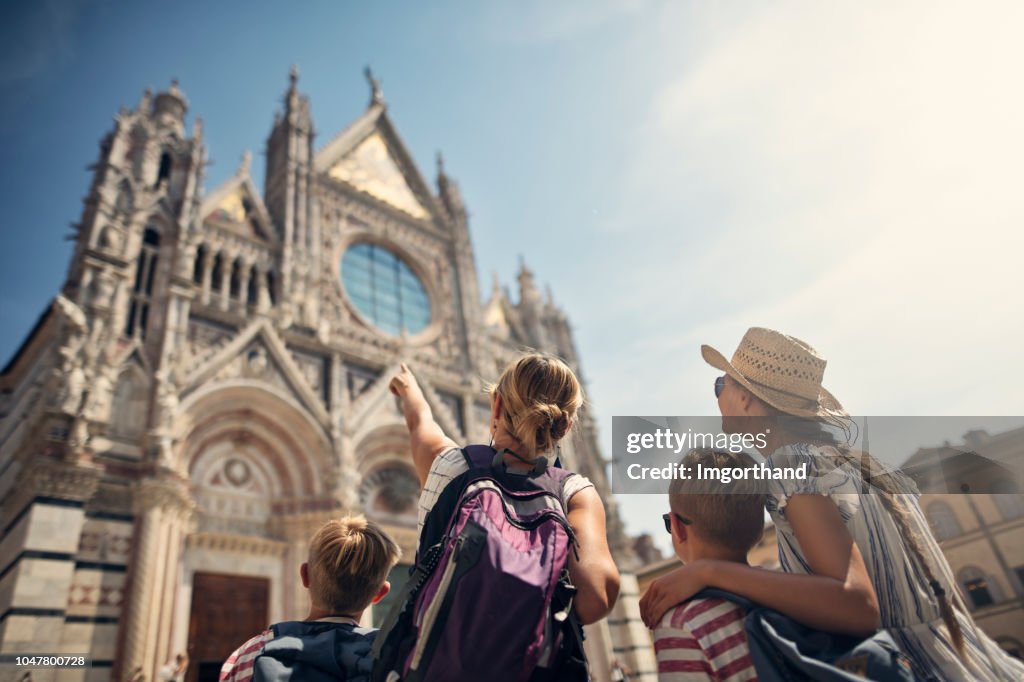 Mother and kids sightseeing city of Siena, Tuscany, Italy