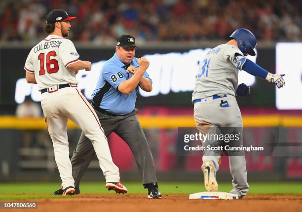 Umpire Doug Eddings calls Joc Pederson of the Los Angeles Dodgers out at second base next to Charlie Culberson of the Atlanta Braves during the...