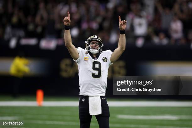 Drew Brees of the New Orleans Saints reacts after throwing a 62 yard pass to take the all time yardage record against the Washington Redskins at...