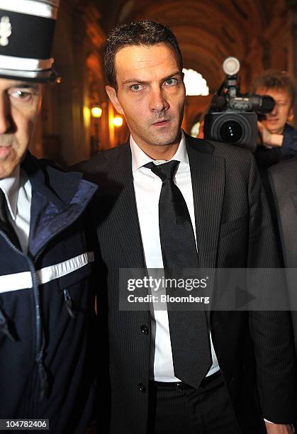 Jerome Kerviel, former Societe Generale SA trader, center, arrives at a courthouse in Paris, France, on Tuesday, Oct. 5, 2010. Kerviel was found...