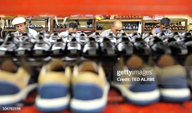 By Mynardo Macaraig Labourers work at a shoe factory in Marikina City, Rizal province, east of Manila on July 13, 2010. They owned the world's...