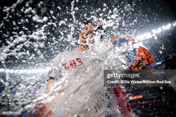 Brock Holt of the Boston Red Sox is doused with Gatorade after hitting for the cycle after game three of the American League Division Series against...