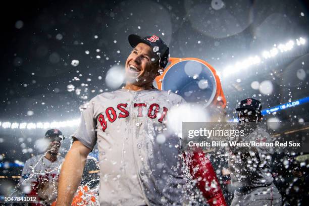 Brock Holt of the Boston Red Sox is doused with Gatorade after hitting for the cycle after game three of the American League Division Series against...