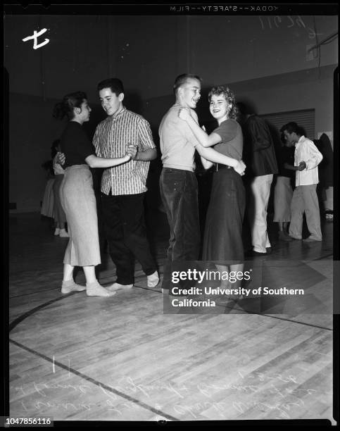 Dana Junior High School in San Pedro remove shoes to prevent damaging floor of new gym, 3 January 1956. Judy Mendenhall;Elaine Panousis;Joyce...