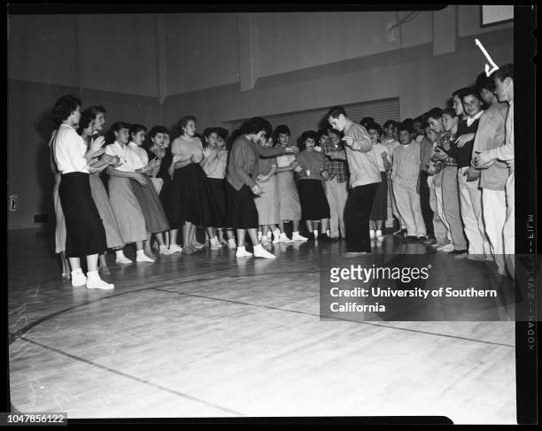 Dana Junior High School in San Pedro remove shoes to prevent damaging floor of new gym, 3 January 1956. Judy Mendenhall;Elaine Panousis;Joyce...