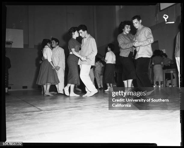 Dana Junior High School in San Pedro remove shoes to prevent damaging floor of new gym, 3 January 1956. Judy Mendenhall;Elaine Panousis;Joyce...