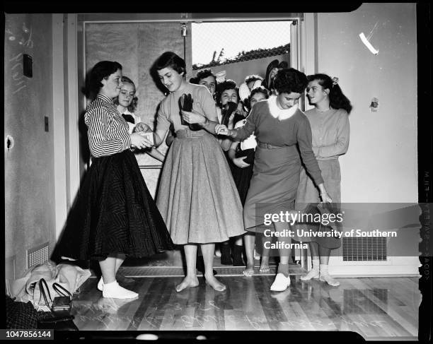 Dana Junior High School in San Pedro remove shoes to prevent damaging floor of new gym, 3 January 1956. Judy Mendenhall;Elaine Panousis;Joyce...