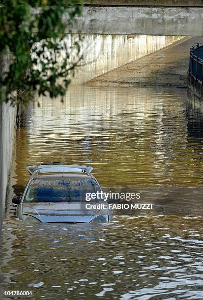 Car is flooded in an underpass in Prato, near Florence on October 5, 2010. Three Chinese women were found dead in another car at the same underpass...