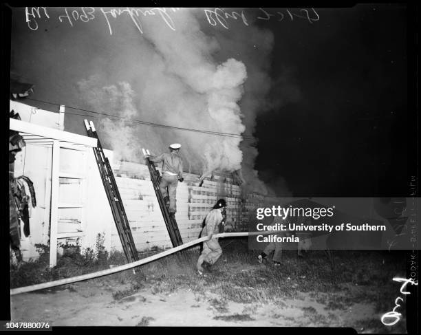 North Hollywood fire at 4093 Lankershim Boulevard , 31 July 1957. Firemen fighting flames, etc;Caption slip reads: 'Photographer: Wesselmann. Date: ....