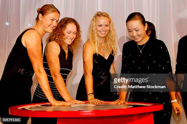 Dinara Safina of Russia Samantha Stosur of Australia, Caroline Wozniacki of Denmark and Shuai Peng of China make an inprint of their plams at a...