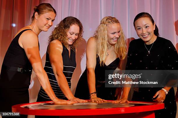 Dinara Safina of Russia Samantha Stosur of Australia, Caroline Wozniacki of Denmark and Shuai Peng of China make an inprint of their plams at a...