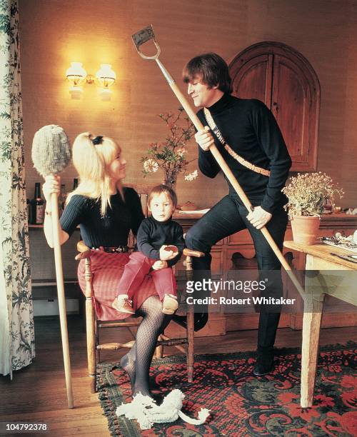 Singer and songwriter John Lennon of The Beatles, with his first wife Cynthia and their son Julian, at their home at Kenwood, Weybridge, Surrey, May...