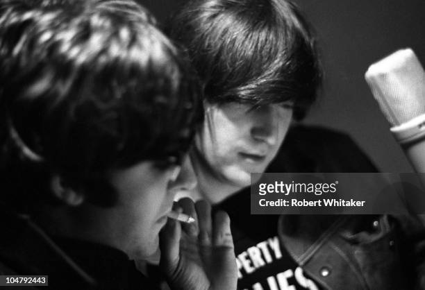 Paul McCartney and John Lennon are pictured during the recording of The Beatles annual Christmas message to their fan club at Marquee Studios in...