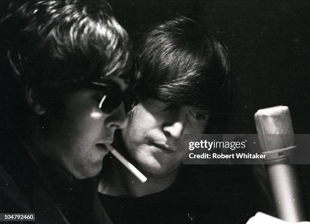 Paul McCartney and John Lennon are pictured during the recording of The Beatles annual Christmas message to their fan club at Marquee Studios in...