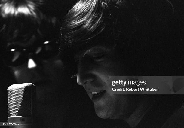 Paul McCartney and John Lennon are pictured during the recording of The Beatles annual Christmas message to their fan club at Marquee Studios in...