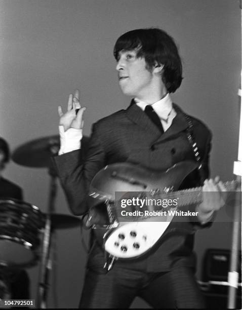 Singer and songwriter John Lennon performing on stage with The Beatles, during their US tour, August 1965.