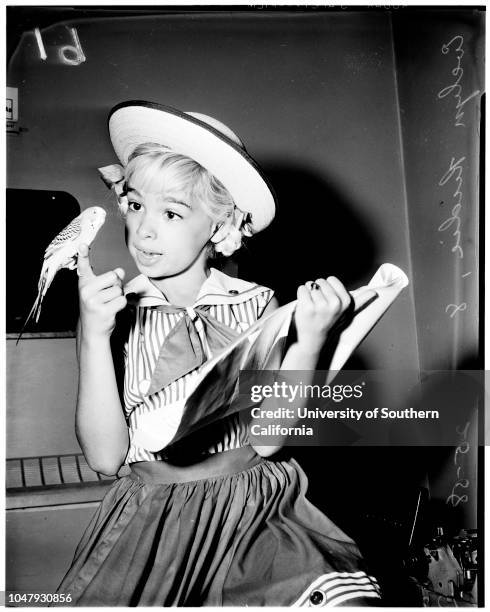 Contract approval, 25 July 1958. Evelyn Rudie -- 8 years;Parakeet 'Pootsy'.;Caption slip reads: 'Photographer: Jim Brezina. Date: . Assignment:...