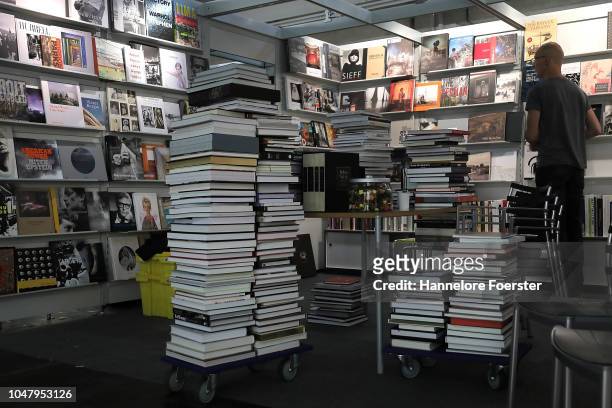 An employee prepare books at an exhibitor's stand prior to the opening of the Frankfurt Book Fair on October 9, 2018 in Frankfurt, Germany....