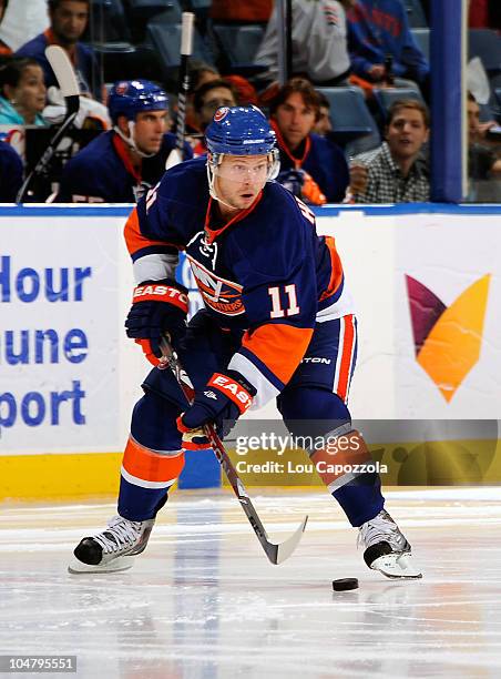 Andy Hilbert of the New York Islanders skating with the puck during a game against the New Jersey Devils at Nassau Veterans Memorial Coliseum on...