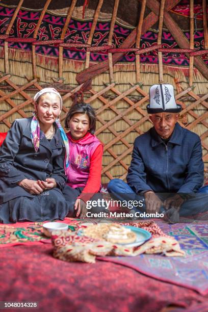 kyrgyz family inside a yurt, xinjiang, china - kyrgyzstan people stock pictures, royalty-free photos & images