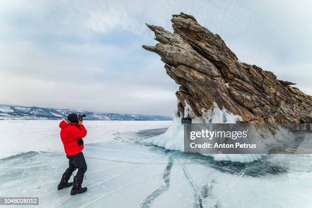 photographer on the background of ogoy island, lake baikal, russia - lake baikal stock pictures, royalty-free photos & images