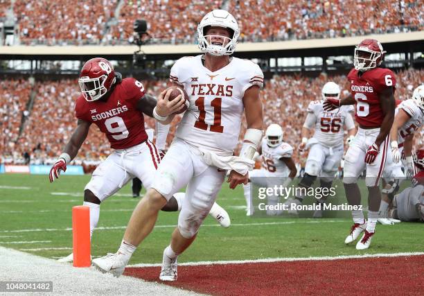 Sam Ehlinger of the Texas Longhorns smiles as he runs into the endzone for a touchdown against the Oklahoma Sooners in the second quarter of the 2018...